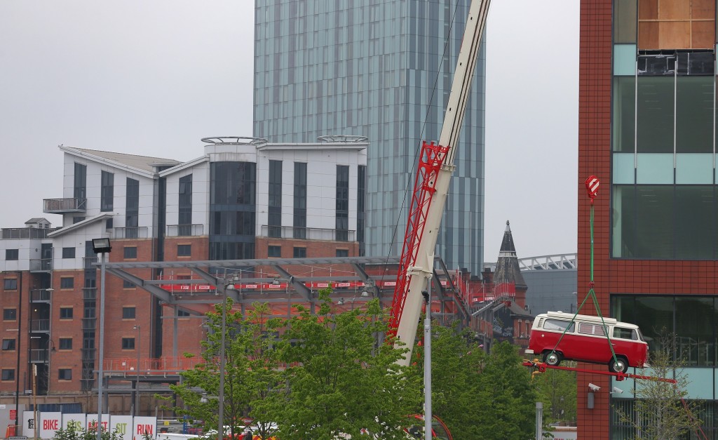 VW Camper being craned into the Manchester buiding