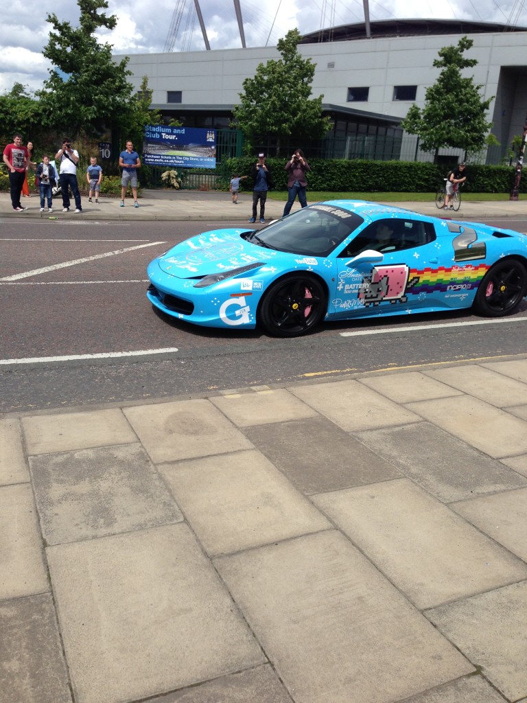 Deadmau5 in his "Purrari" nyan cat theme wrapped Ferrari 458